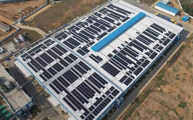 Aerial view of a large industrial rooftop solar installation